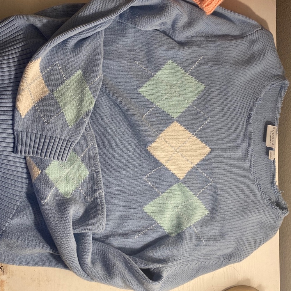 Light blue argyle sweater.